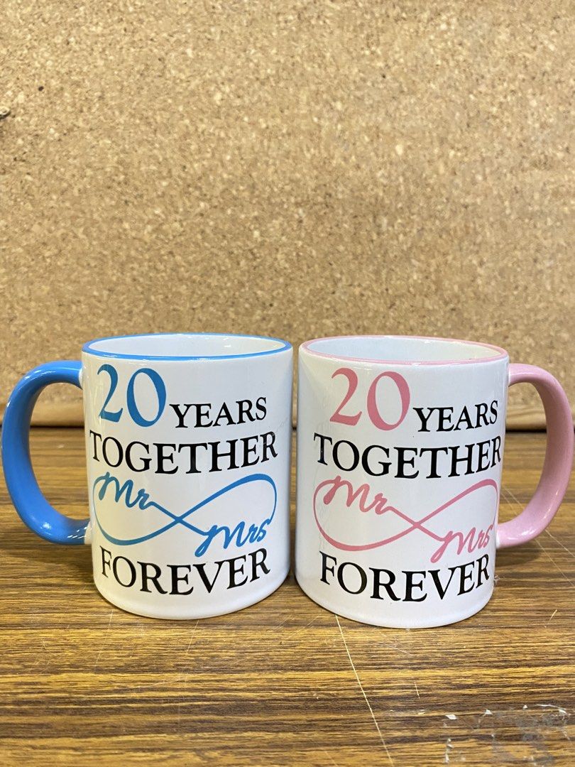 Anniversary Mug 20 Years Together Mr & Mrs (Category: Coffee & Tea Tableware) located in Calamba. Submitted by chebvintagedepot (Listing ID 1465064564, Image 1). Description: [B23-03] These ceramic coffee mugs are a matching pair celebrating a 20th anniversary, with one blue and one pink mug. The simple commemorative design makes them suitable for everyday coffee use, display, or as an anniversary gift. Note: Comes with a box. Please refer to the