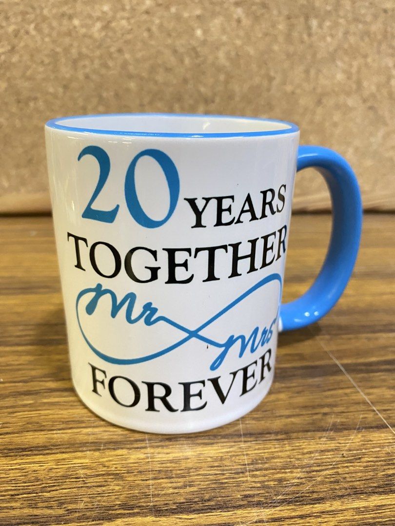 Anniversary Mug 20 Years Together Mr & Mrs (Category: Coffee & Tea Tableware) located in Calamba. Submitted by chebvintagedepot (Listing ID 1465064564, Image 3). Description: [B23-03] These ceramic coffee mugs are a matching pair celebrating a 20th anniversary, with one blue and one pink mug. The simple commemorative design makes them suitable for everyday coffee use, display, or as an anniversary gift. Note: Comes with a box. Please refer to the