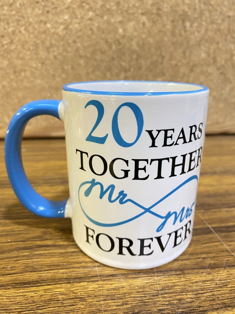 Anniversary Mug 20 Years Together Mr & Mrs (Category: Coffee & Tea Tableware) located in Calamba. Submitted by chebvintagedepot (Listing ID 1465064564, Image 2). Description: [B23-03] These ceramic coffee mugs are a matching pair celebrating a 20th anniversary, with one blue and one pink mug. The simple commemorative design makes them suitable for everyday coffee use, display, or as an anniversary gift. Note: Comes with a box. Please refer to the