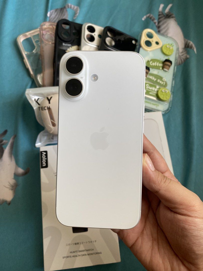Apple iPhone 16 White with Original Box and Cases (Category: iPhone 16 Series) located in Iloilo. Submitted by angelenepe01084 (Listing ID 1465097713, Image 2). Description: - Model: Apple iPhone 16 (White) - Condition: Clean screen, excellent working condition - Inclusions: Original retail box, several protective cases, packaged earbuds, and an extra smartwatch - Note: All items pictured are included as a complete bundle - Reason for selling: Up