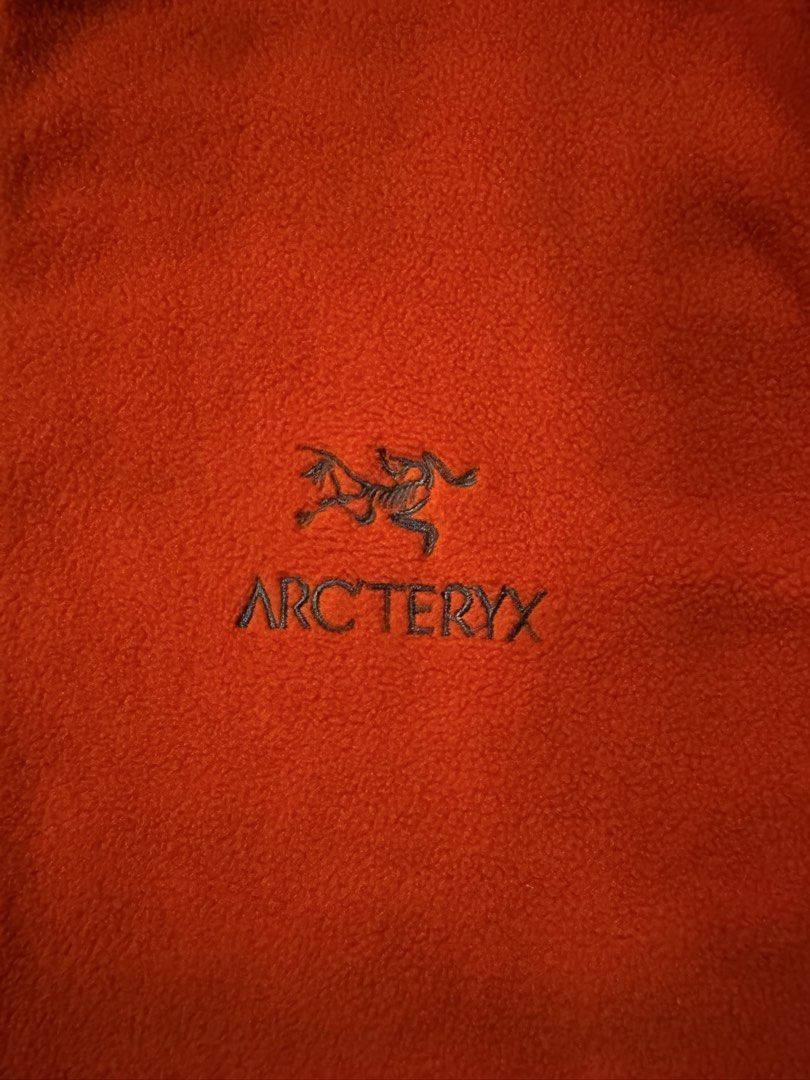 Arc'teryx Orange Fleece Zip Jacket (Category: Coats, Jackets and Outerwear) located in Caloocan City. Submitted by gabbieerfritter (Listing ID 1465140007, Image 2). Description: - Brand: Arc'teryx - Color: Bright orange with contrasting grey collar and cuffs - Hardware: Durable YKK full front zip - Details: Embroidered logo on the chest - Fit & Comfort: Warm, soft fleece material ideal for outdoor activities or casual daily wear.