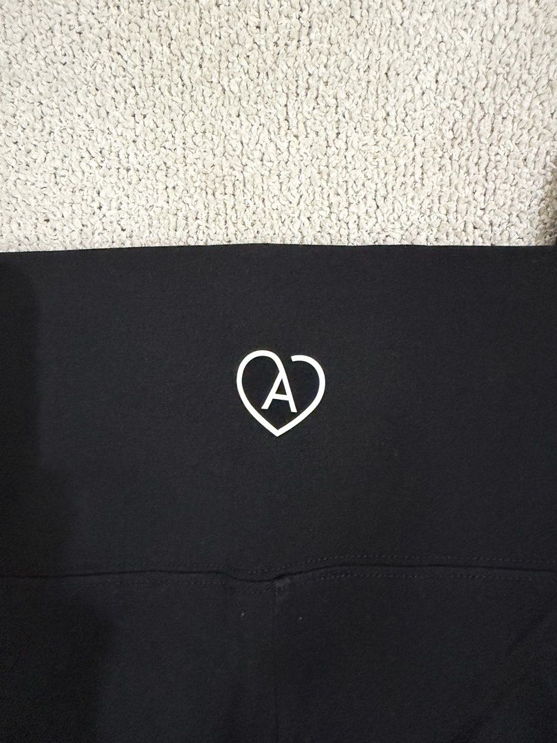 Aritzia Black Leggings 1X (Category: Activewear) located in Subic. Submitted by kittysclosetsale (Listing ID 1465015604, Image 3). Description: - Brand: Aritzia - Size: 1X (tag attached) - Color: Black - Condition: Brand new with tags - Features: High-waisted, cute heart logo on back waistband, interior brand/care print - Material: Soft and stretchy - Origin: Made in Cambodia - Versatile basic for daily wear or workouts.