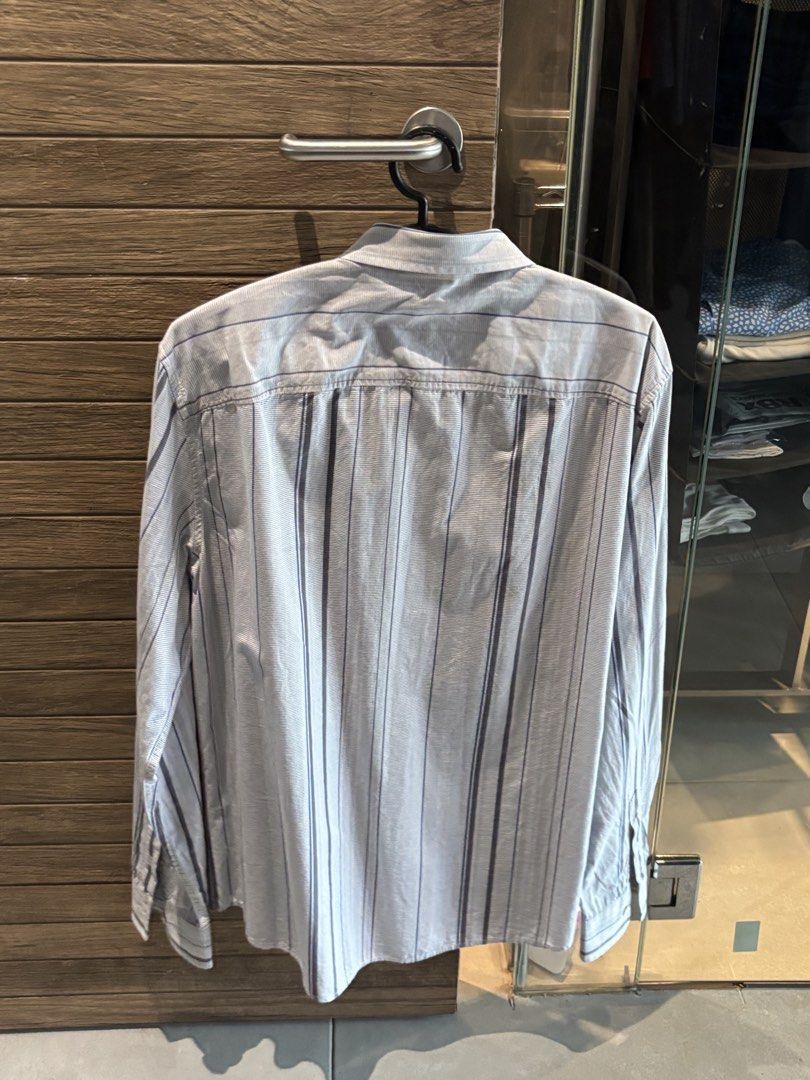 Armani Exchange Striped Long Sleeve Button-Down Shirt Size M (Category: Tshirts & Polo Shirts ) located in Quezon City. Submitted by tanmiguel1998 (Listing ID 1465005169, Image 3). Description: - Brand: Armani Exchange - Design: Blue and white pinstripe pattern with vertical stripe accents - Details: Classic collar, front button closure, long sleeves with button cuffs - Size: Medium (M) - Origin: Made in China - Condition: Clean fabric, excellent