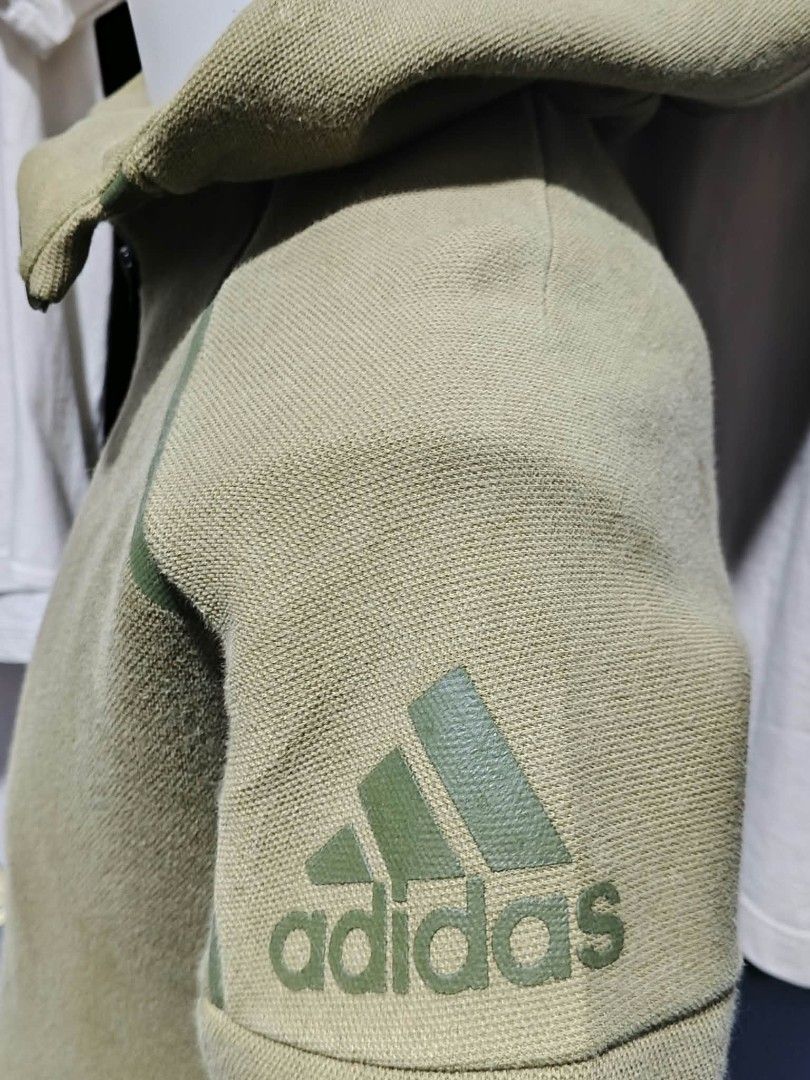 Army Jacket (Category: Coats, Jackets and Outerwear) located in Bulacan. Submitted by ukaybrandedshop (Listing ID 1465020029, Image 3). Description: Adidas Full Zip Hoodie - Olive Green Size: M-L | Dimes: W22 L26 (paki-edit) Condition 9/10 makapal, no fade, good zipper Issue: may maliit na tuldok / pin hole sa sleeve - maliit lang, di halata pag suot (see pic) ₱750 / J&T / Lalamove PM lang.