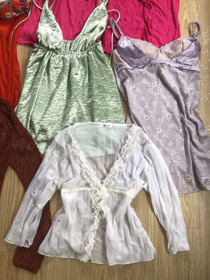 Assorted Y2K boho camis, tops and cardigans bundle (Category: Blouses) located in Manila. Submitted by tunicy2k (Listing ID 1465022893, Image 3). Description: - Bundle of 10 different tops and camisoles - Includes plaid halter, floral blouse, pastel green cami, beaded white tank, pink ruffled shirts, orange halter, metallic green swing cami, floral satin slip dress, brown crochet cardigan, and white sheer lace-trim top - Mix of bohemian and Y2K a