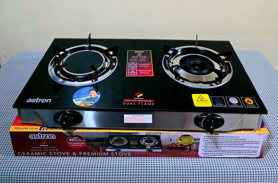 Astron Dual Flame Ceramic and Premium Gas Stove (Category: Cookers) located in Manila. Submitted by kisshadg23 (Listing ID 1465123773, Image 1). Description: - Brand new in original box - Dual burner setup with ceramic and premium burners for faster meal prep - Sleek black glass top surface with durable stainless steel body - Low gas consumption and high gas efficiency for quick cooking time - Tested working dials.