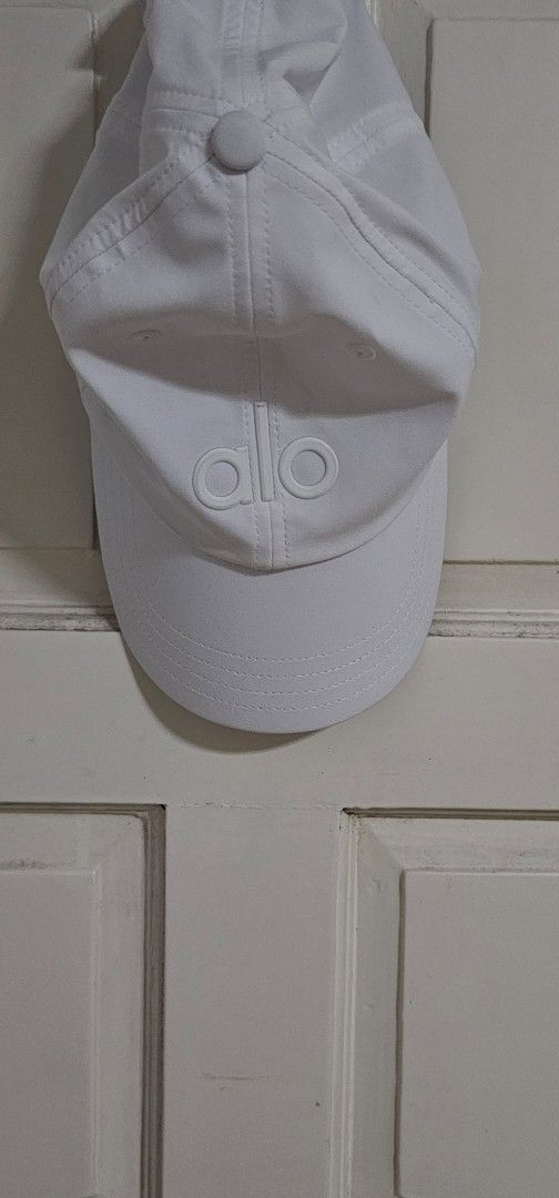 Authenric Alo Yoga White Cap (Category: Caps & Hats) located in Davao. Submitted by sachigo (Listing ID 1465078872, Image 1). Description: - Brand: Alo Yoga - Color: Clean White - Design: Classic raised logo on front - Fit: One size fits most (adjustable strap) - Condition: Brand new with internal tags - Origin: Made in China - Ideal for: Gym workouts, running errands, or casual streetwear - PM for quick transactions and shipping!.