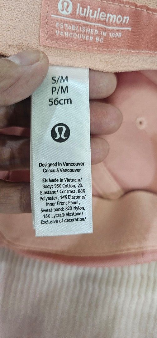 Authenric Lululemon pink cap size S/M (Category: Hats & Beanies) located in Davao. Submitted by sachigo (Listing ID 1465079179, Image 2). Description: - Authentic Lululemon baseball cap in a stylish pink shade - Size S/M (measures approximately 56cm) - Body: Cotton and elastane blend for comfortable stretch - Inner front band: Nylon and Lycra elastane for a secure, sweat-wicking fit - Classic curved brim design with subtle embroidered branding on