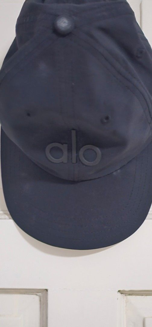 Authentic Alo Yoga Black Baseball Cap (Category: Caps & Hats) located in Davao. Submitted by sachigo (Listing ID 1465079064, Image 1). Description: - Brand: Alo Yoga - Color: Classic black with bold raised logo - Fit: Adjustable strap back (One size fits most) - Material: Lightweight fabric - Condition: Clean interior lining with standard brand care tag included - Ideal for: Workouts or everyday casual wear.