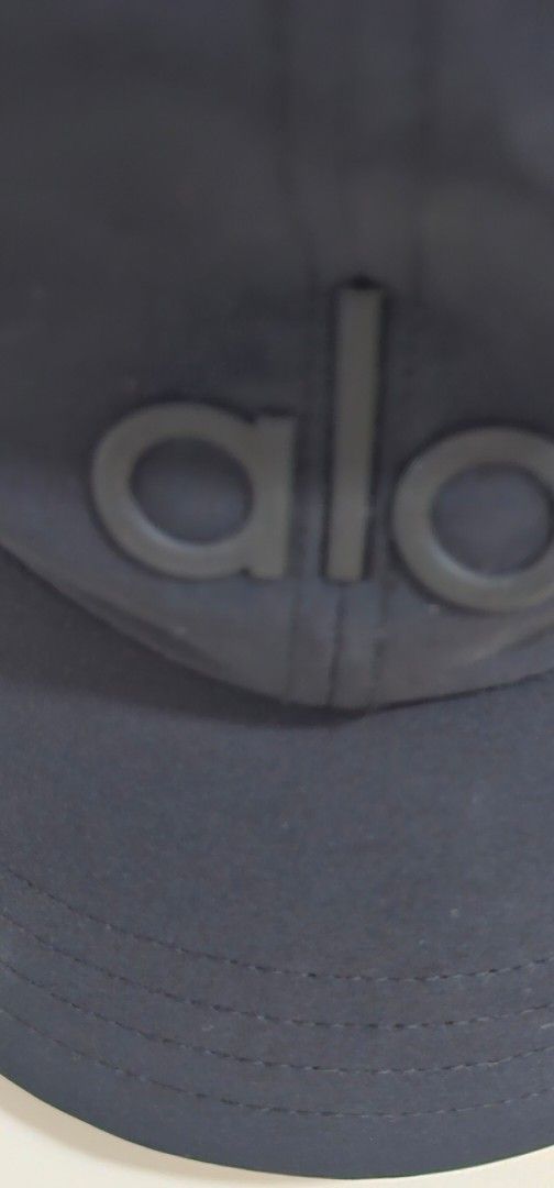 Authentic Alo Yoga Black Baseball Cap (Category: Caps & Hats) located in Davao. Submitted by sachigo (Listing ID 1465079064, Image 3). Description: - Brand: Alo Yoga - Color: Classic black with bold raised logo - Fit: Adjustable strap back (One size fits most) - Material: Lightweight fabric - Condition: Clean interior lining with standard brand care tag included - Ideal for: Workouts or everyday casual wear.