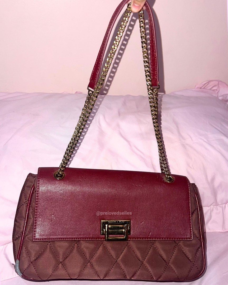 AUTHENTIC Burgundy Charles & Keith Quilted Bag (Category: Luxury Bags & Wallets) located in Kawit. Submitted by prelovedselles (Listing ID 1465056546, Image 2). Description: This maroon/burgundy piece was only used once and kept in the closet ever since. The interior lining, gold hardware, chain strap, and front flap are in good, practically brand-new condition! ⚠️ Please note: Due to long-term closet storage and humidity, there is noticeable pee