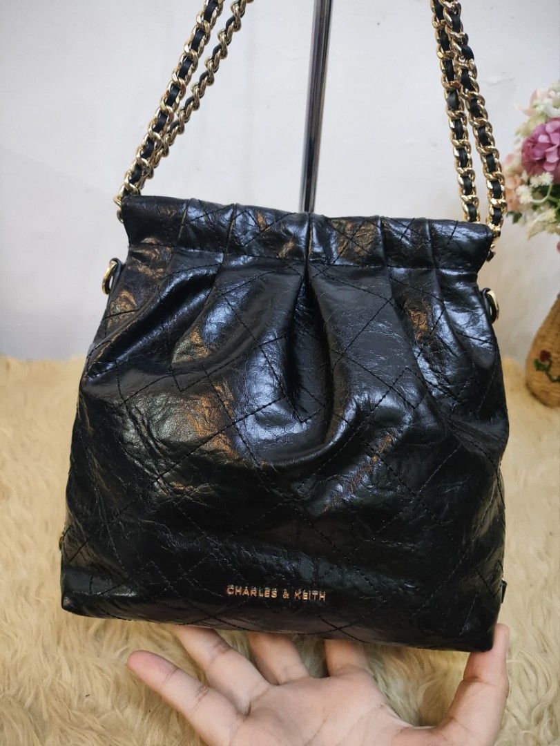 Authentic Charles & Keith duo chain shoulder bag (Category: Shoulder Bags) located in Rizal. Submitted by hsiri1128 (Listing ID 1465085099, Image 2). Description: 💯✔️Legit CONDITION : 9/10 ISSUE / FLAWS : Missing ung long chain nya para maging back pack xa and sling. MATERIAL : Faux Leather w/ gold hardwares DETAILS : Fit notebook and long wallet. very black in actual, no visible rubs/bakbak. magnetic closure.