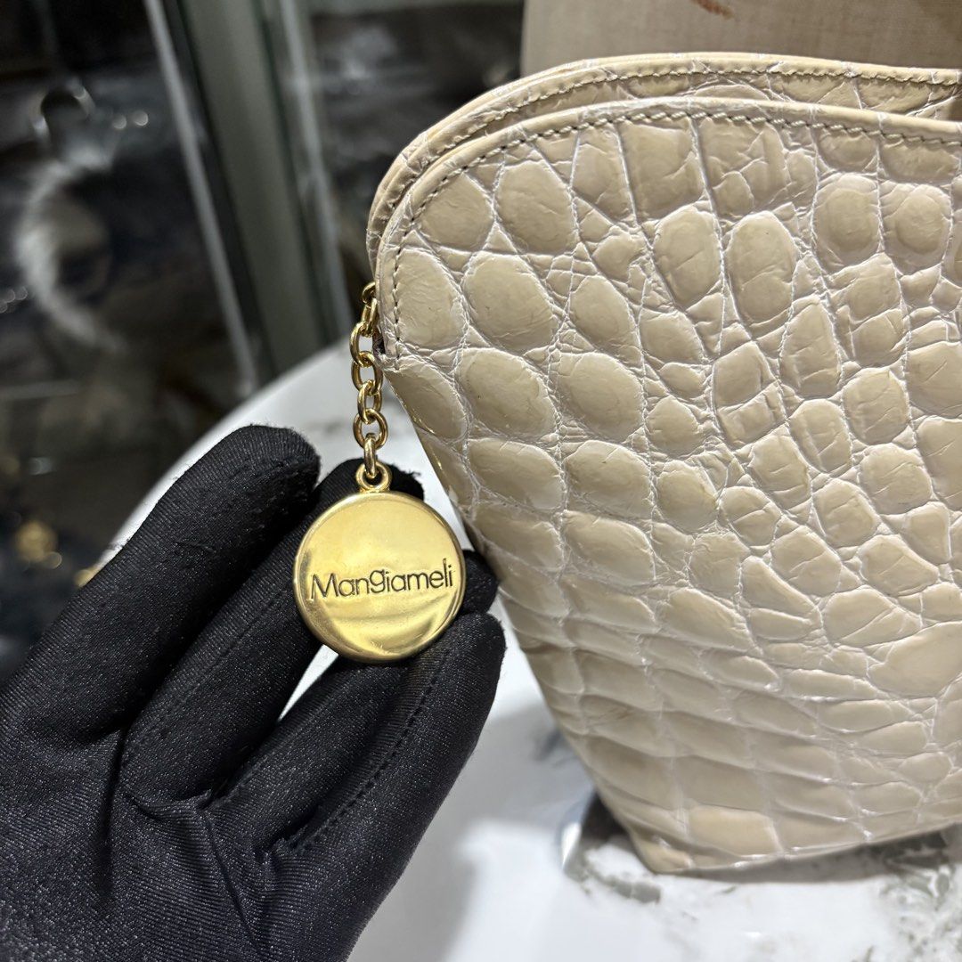 Authentic Egal by Mangiameli Genuine Crocodile Hand bag (Category: Purses & Pouches) located in Binangonan. Submitted by makoleksyon (Listing ID 1465017443, Image 3). Description: Excellent condition Like new No flaws Rare Size: H-7 x W-9.5 x D-2 inches Made in Italy Real crocodile leather Opti zipper Bought in Japan 💯% Authentic Money back guarantee Bought in Japan 💯% Authentic Money back guarantee .