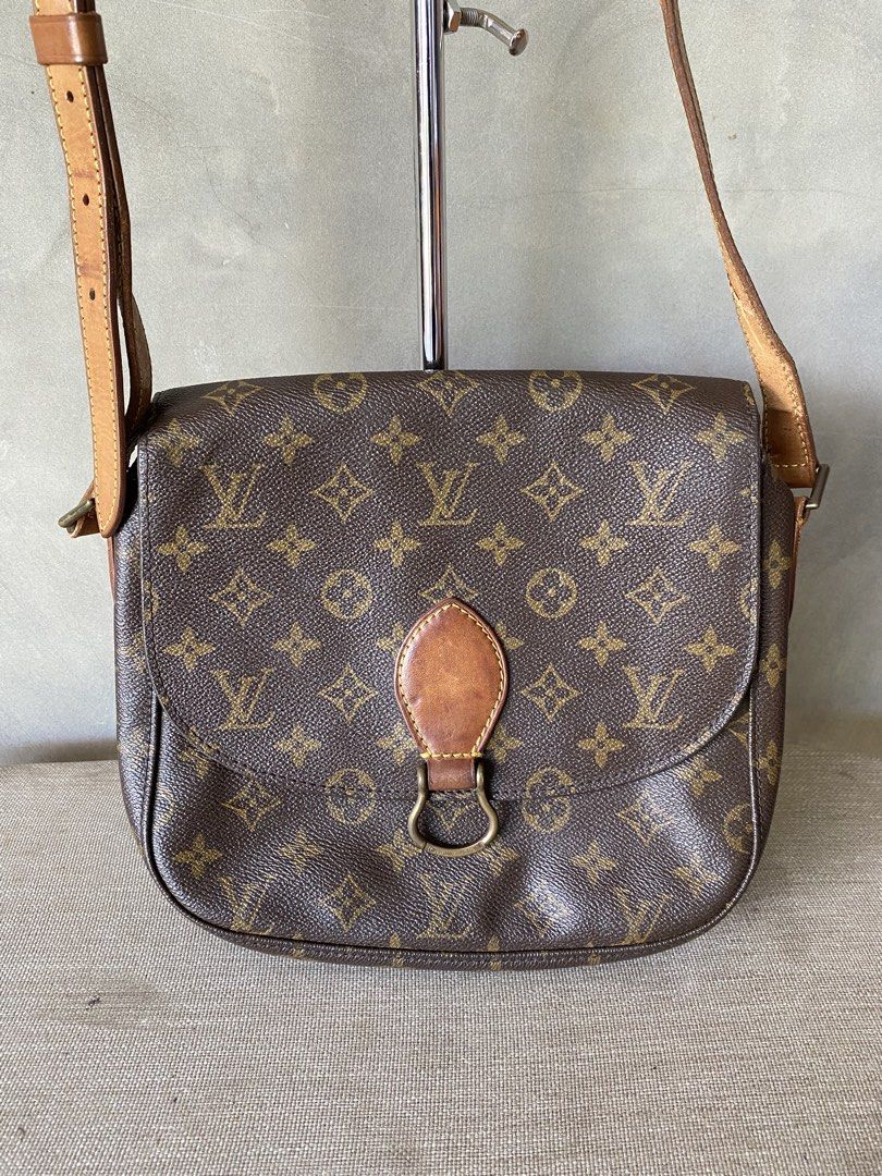 Authentic Louis Vuitton Saint Cloud MM Crossbody Bag (Category: Luxury Bags & Wallets) located in Manila. Submitted by why_notph (Listing ID 1465102902, Image 2). Description: - Authentic Louis Vuitton shoulder bag - Iconic monogram canvas with vachetta leather trim - Secure flap closure with stylish ring accent - Adjustable shoulder strap with comfortable shoulder pad - Normal issue on the strap parts since this was release on the 90s - Brown le