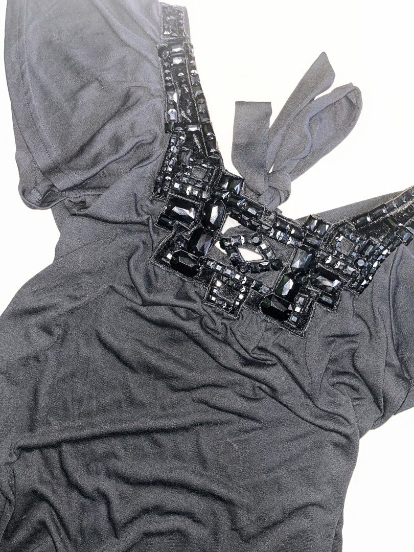 a.y.k. Black Blouse with Beaded Neckline (Category: Blouses) located in Dagupan City. Submitted by shanadongsb (Listing ID 1465027997, Image 3). Description: - Brand: a.y.k. - Color: Black - Neckline: Deep V-neck with heavy black rhinestone and gem details - Sleeves: Short flutter sleeves for a relaxed fit - Back detail: Adjustable tie-back at the neckline - Fabric: Soft and stretchy for comfortable wear - Condition: Excellent / As good as new - 