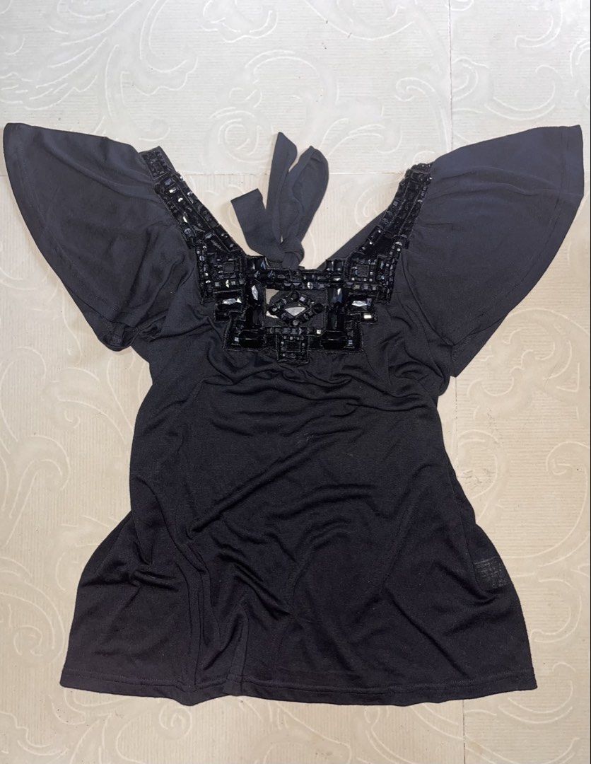 a.y.k. Black Blouse with Beaded Neckline (Category: Blouses) located in Dagupan City. Submitted by shanadongsb (Listing ID 1465027997, Image 1). Description: - Brand: a.y.k. - Color: Black - Neckline: Deep V-neck with heavy black rhinestone and gem details - Sleeves: Short flutter sleeves for a relaxed fit - Back detail: Adjustable tie-back at the neckline - Fabric: Soft and stretchy for comfortable wear - Condition: Excellent / As good as new - 