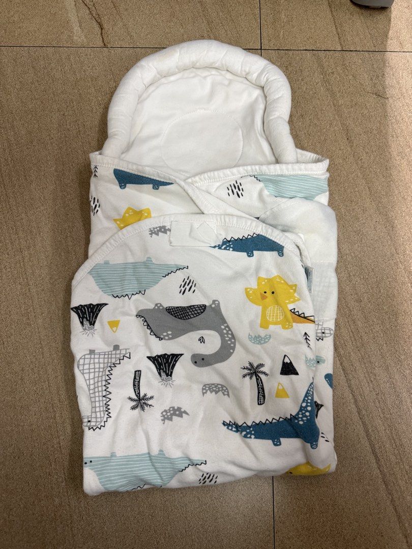 Baby Swaddle Blanket Wrap Dinosaur Print (Category: Babies & Kids Fashion) located in Pasig City. Submitted by cvj25 (Listing ID 1465009566, Image 1). Description: - Adorable dinosaur and volcano print on a white background - Made from 100% breathable cotton, gentle on newborn skin - Padded hood keeps baby's head warm and cozy - Secure velcro closure flap for easy wrapping and adjusting - Lightweight and easy to fold, perfect for daily use.