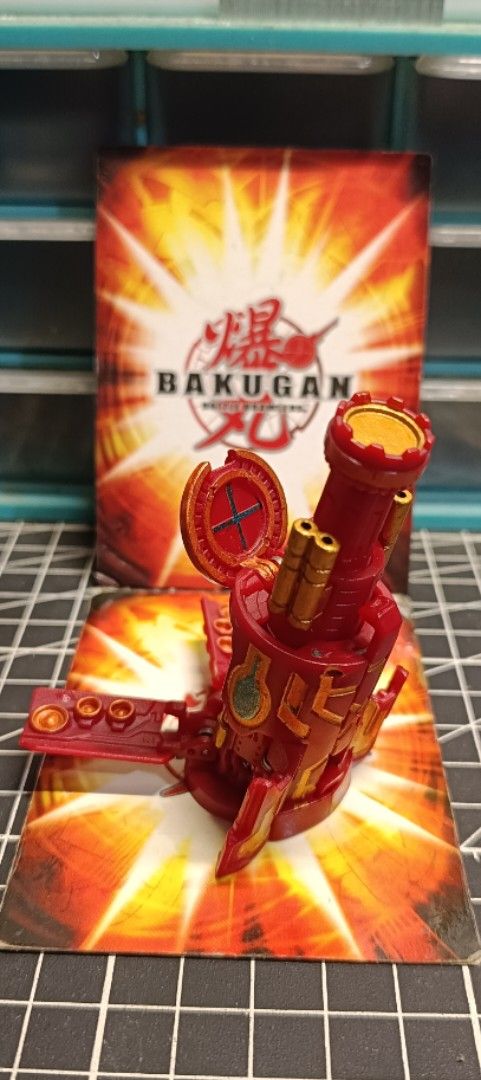 Bakugan Gundalian Invaders: Zukanator (Category: Action & Battle Toys) located in Binan City. Submitted by sir_macs (Listing ID 1465098315, Image 1). Description: - Type: Red Bakugan Battle Gear tower toy - Design: Features striking metallic gold and blue details - Gameplay: Stands upright securely on its gate card - Features: Foldable side panels and interactive moving parts - Condition: Perfect addition to upgrade any Bakugan collection or setu