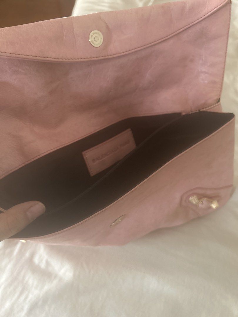 Balenciaga Pink Leather Envelope Clutch (Category: Luxury Bags & Wallets) located in Manila. Submitted by eeerk (Listing ID 1464970406, Image 3). Description: - Brand: Balenciaga - Style: Envelope clutch in soft pink leather - Hardware: Gold-toned with signature stud and buckle details - Closure: Fold-over flap with magnetic snap - Pockets: Convenient front zip pocket - Interior: Dark lining with Balenciaga Paris leather brand patch - Capacity: S