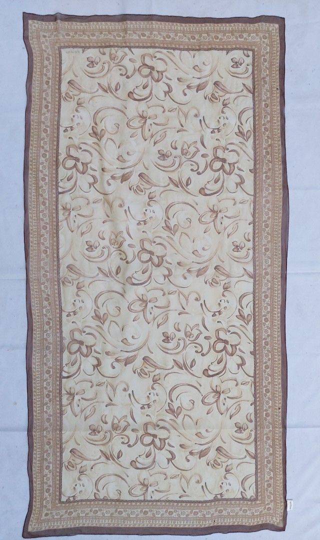 Balmain Paris Floral Pattern Scarf (Category: Scarves) located in Lapu Lapu. Submitted by agnesapm_29813 (Listing ID 1465098689, Image 1). Description: - Brand: Balmain Paris - Color: Cream and brown with floral motif - Design: Center floral print, detailed borders, solid brown rolled edges, and stitched brand label - Material: Lightweight fabric - Measurements: 66 inches x 32 inches .