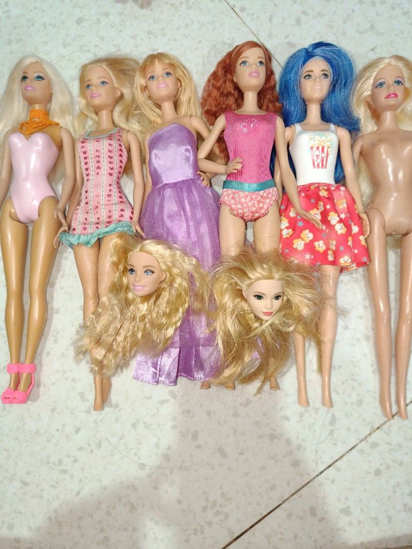 Barbie Dolls (SOLD AS SET) (Category: Kids Toys) located in Taguig. Submitted by pringlesshop2024 (Listing ID 1465165107, Image 1). Description: - Set of 6 fashion dolls - Hair colors: Blonde, red, and blue - Assorted outfits: Pink swimsuits, floral dresses, and purple gowns - Ideal for toy collections or playtime - Selling all together as a set.