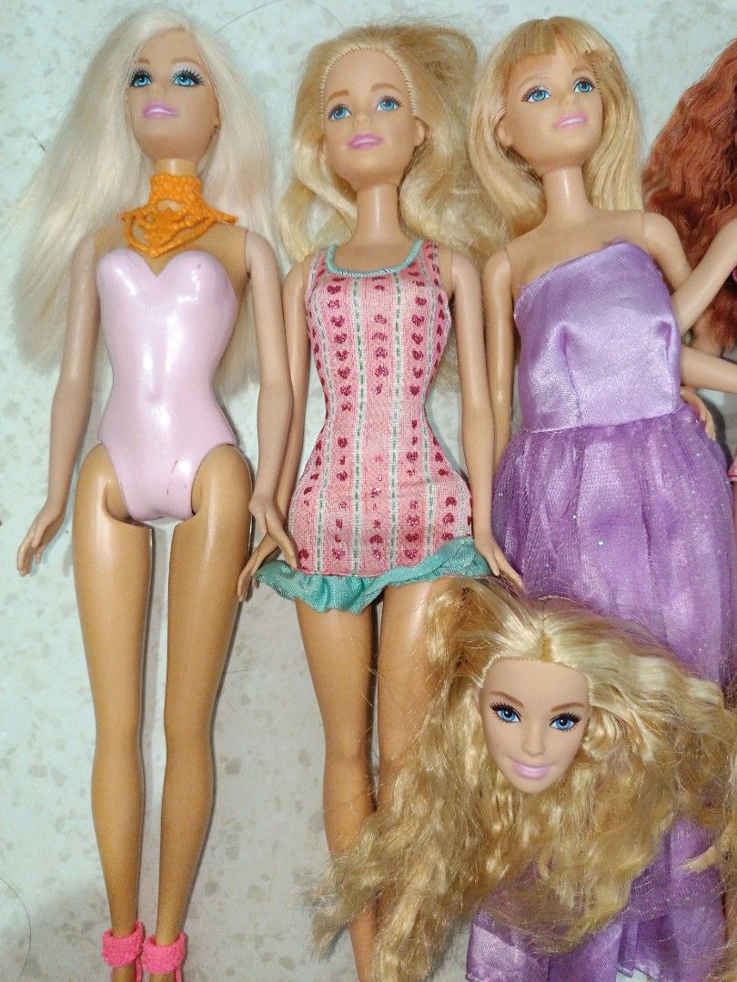 Barbie Dolls (SOLD AS SET) (Category: Kids Toys) located in Taguig. Submitted by pringlesshop2024 (Listing ID 1465165107, Image 2). Description: - Set of 6 fashion dolls - Hair colors: Blonde, red, and blue - Assorted outfits: Pink swimsuits, floral dresses, and purple gowns - Ideal for toy collections or playtime - Selling all together as a set.