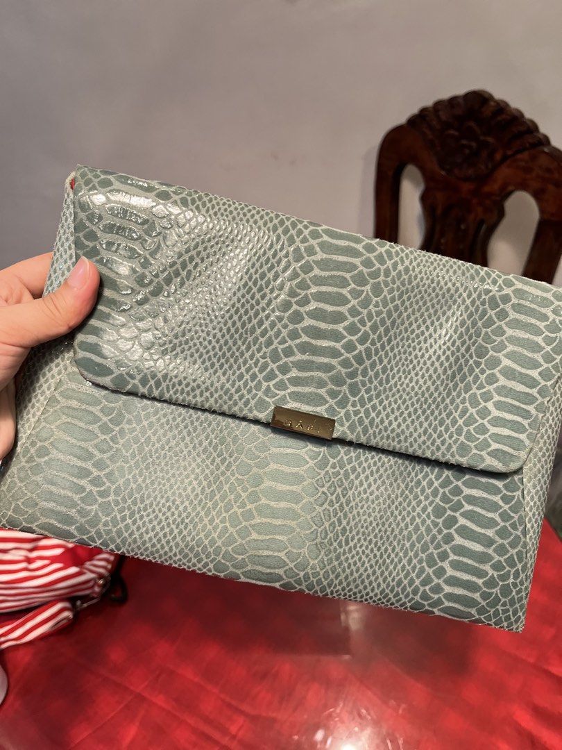 Bari Green Snakeskin Pattern Envelope Clutch Bag (Category: Clutches) located in Manila. Submitted by harpymonetttt (Listing ID 1465103997, Image 1). Description: - Color: Green with stylish snake skin texture - Design: Foldover envelope style with gold metallic Bari logo closure - Interior: Vibrant red fabric lining with a small matching inner pocket - Size: Medium envelope, ideal for parties and dinners - Condition: Clean inside and out, with m