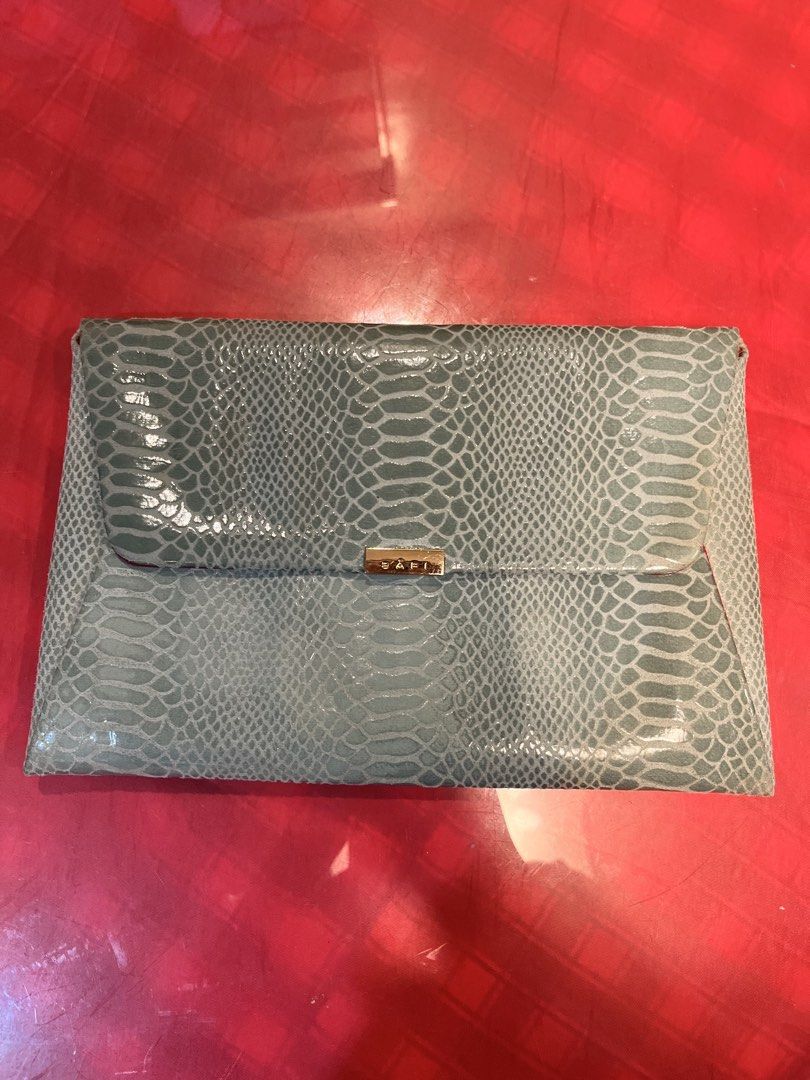 Bari Green Snakeskin Pattern Envelope Clutch Bag (Category: Clutches) located in Manila. Submitted by harpymonetttt (Listing ID 1465103997, Image 2). Description: - Color: Green with stylish snake skin texture - Design: Foldover envelope style with gold metallic Bari logo closure - Interior: Vibrant red fabric lining with a small matching inner pocket - Size: Medium envelope, ideal for parties and dinners - Condition: Clean inside and out, with m