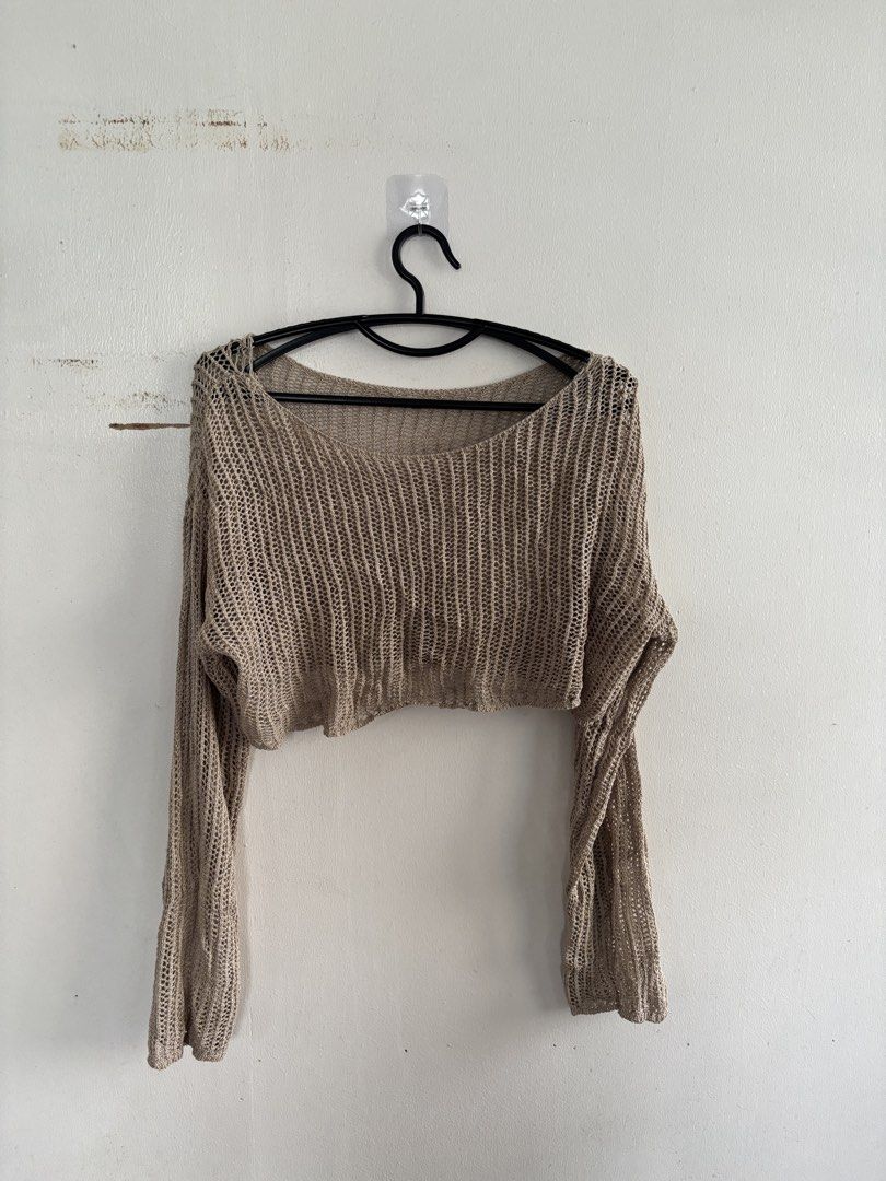 Beige Knitted Long Sleeve Crop Top (Category: Longsleeves) located in Muntinlupa City. Submitted by jc444_ (Listing ID 1465111577, Image 1). Description: - Color: Neutral beige - Style: Long sleeve knitted crop top with scoop neckline - Texture: Lightweight open-knit, loose mesh - Condition: Brand new, unworn (no tags) - Versatility: Great for layering over bralettes or swimsuits.