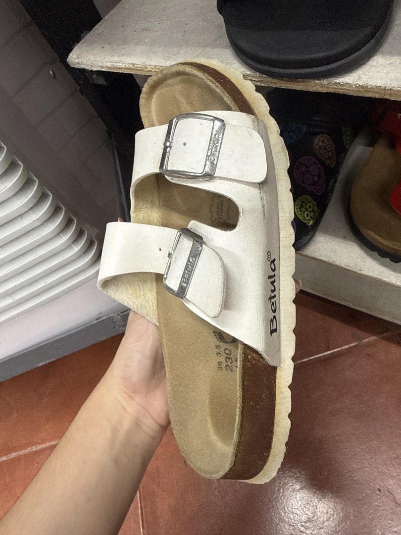 Betula White Double Strap Sandals Size 36 230 (Category: Flats & Sandals) located in Manila. Submitted by fastlion.584bdf (Listing ID 1465061768, Image 2). Description: - Brand/Model: Betula Double Strap Sandals - Color: White - Size: 36 (230 mm) - Material: Cork footbed with suede lining and silver-tone metal buckles - Condition: Normal signs of wear on the straps and footbed - Style: Super comfy, easy slip-on, perfect for casual daily outfits.