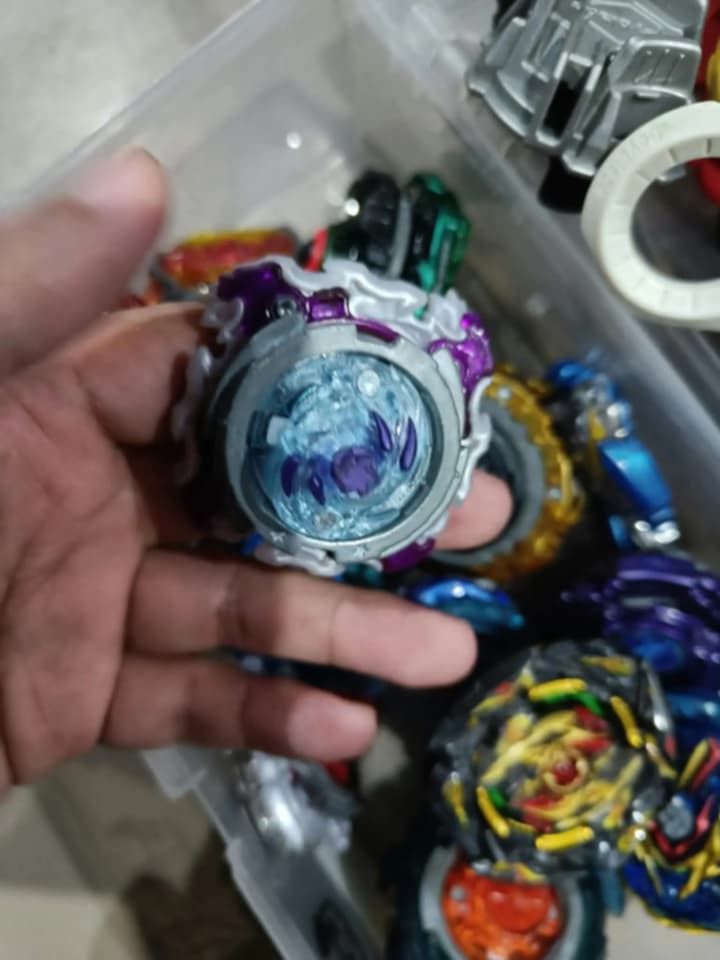 Beyblade Lot (Category: Action & Battle Toys) located in Manila. Submitted by grlfncs.mon31 (Listing ID 1465085538, Image 2). Description: - Complete Beyblade Burst battle set - Includes multiple tops with golden, blue, black, and white layers - Comes with various launcher grips and winders - Includes a clear storage case for easy organization - Great as a starter set or to expand your current collection - Condition: Good / Ready to play - Meet-u