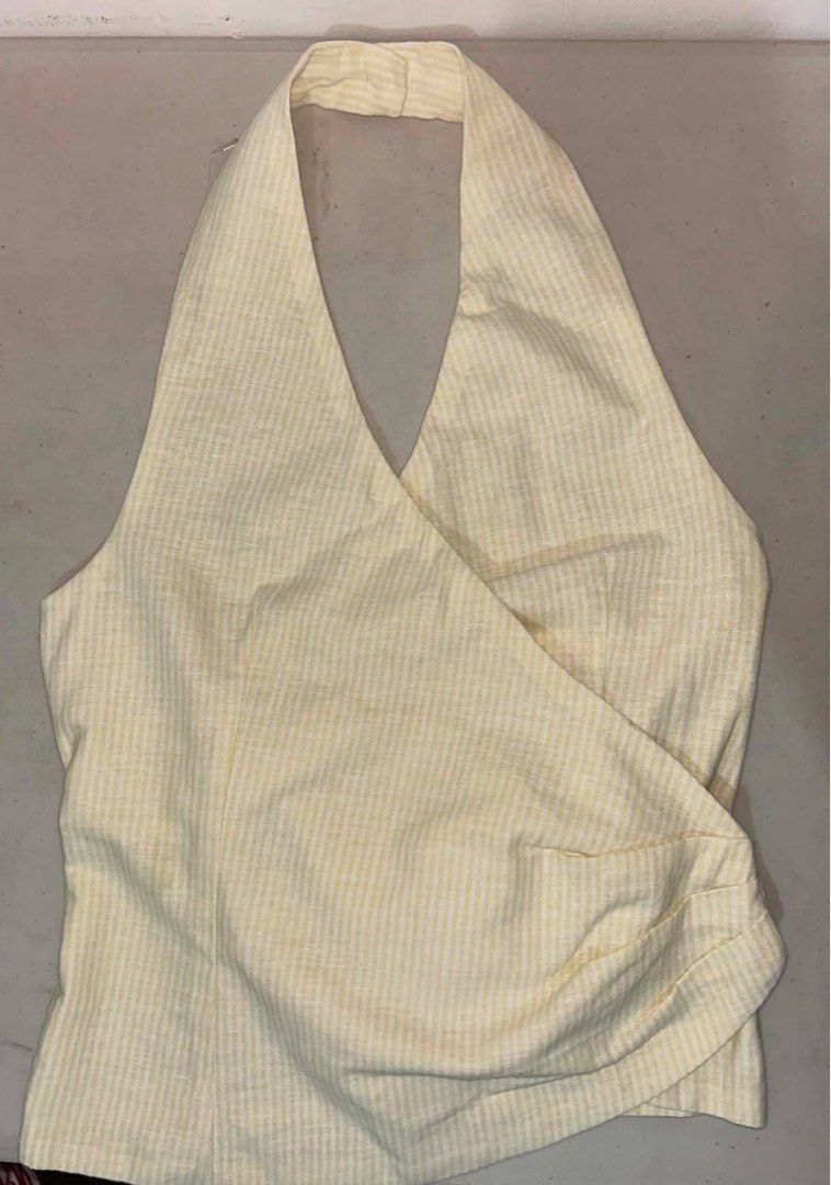 Beyond Collective Lily Top (XS) (Category: Sleeveless) located in Manila. Submitted by d.rosie844 (Listing ID 1465028972, Image 3). Description: - Style: Yellow and white striped halter top with a chic wrap-around design - Neckline: Flattering V-neck cut - Fit: Adjustable waist with a side tie ribbon for a custom fit - Versatility: Pairs easily with skirts or high-waisted shorts.