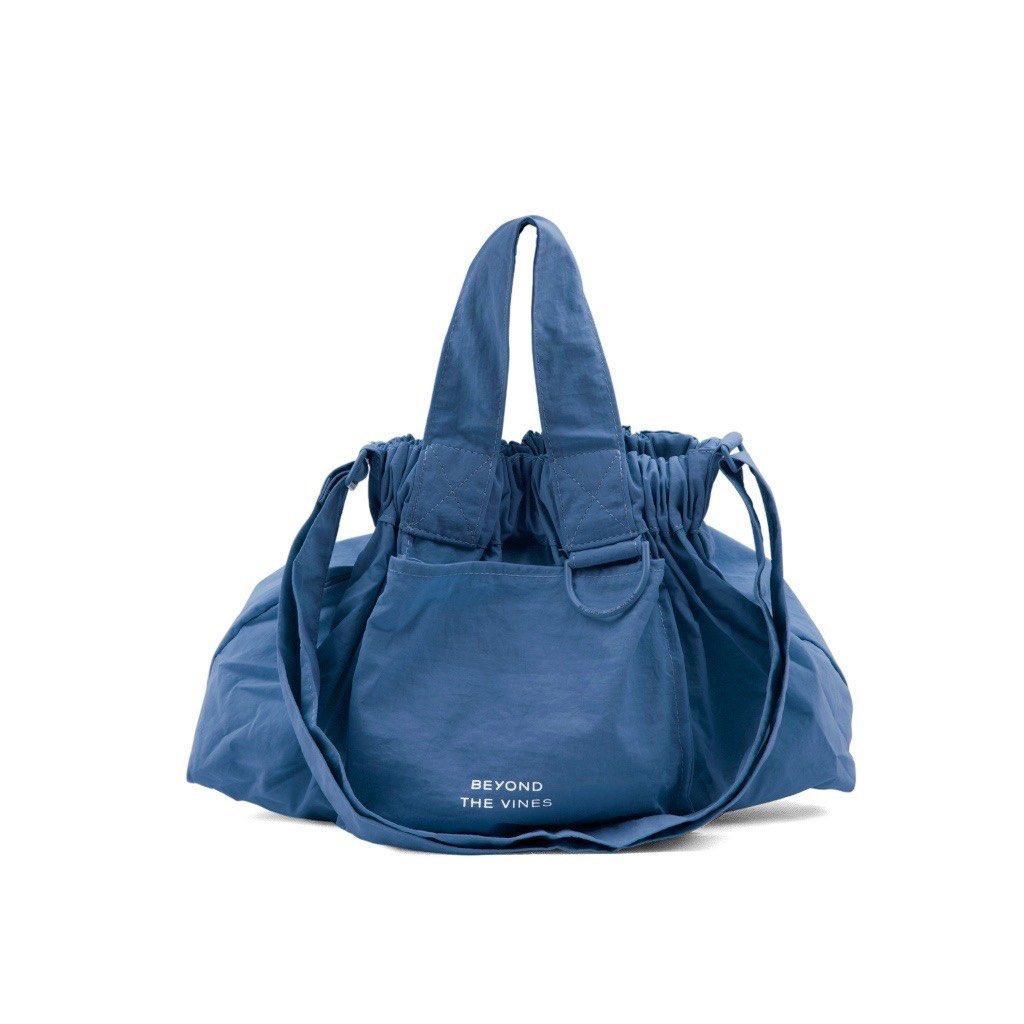 Beyond The Vines Dumpling Bag MEDIUM (Category: Tote Bags) located in Bacoor. Submitted by faith.hope.love28 (Listing ID 1464986282, Image 1). Description: - Brand: Beyond The Vines - Colors available: Blue and Terracotta - Versatile carry: Dual top handles and adjustable shoulder straps included - Functional design: Front exterior pocket with printed brand lettering and a D-ring attachment - Secure closure: Gathered cinch top design with drawstr