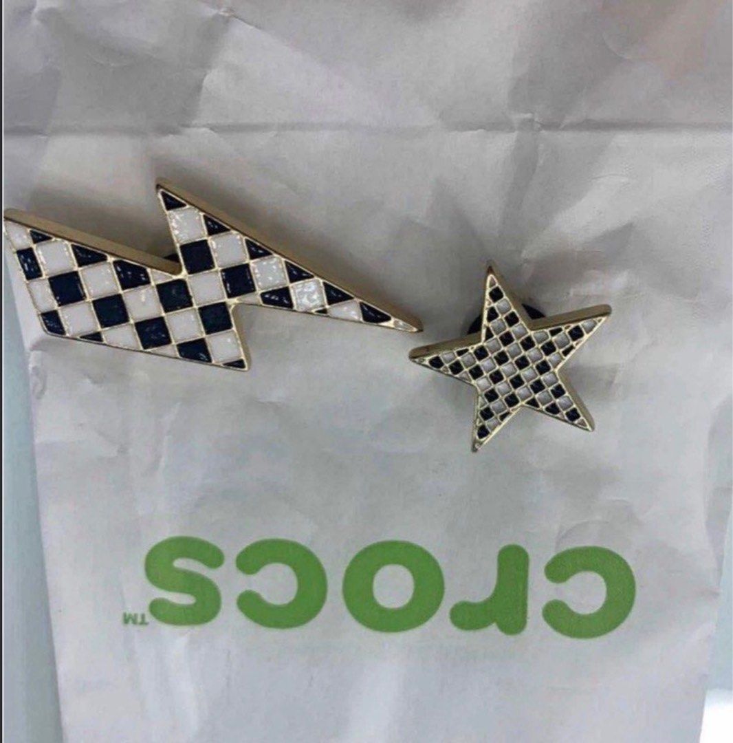 Black and white checkered Crocs jibbitz charms (Category: Charms) located in Manila. Submitted by decluterthings888 (Listing ID 1465109633, Image 1). Description: - Set of 2 metal Crocs charms - Designs: Star and lightning bolt - Pattern: Black and white checkered with chic gold-tone trim - Easy to attach and remove from shoe ventilation holes - Fun and trendy way to customize your footwear.