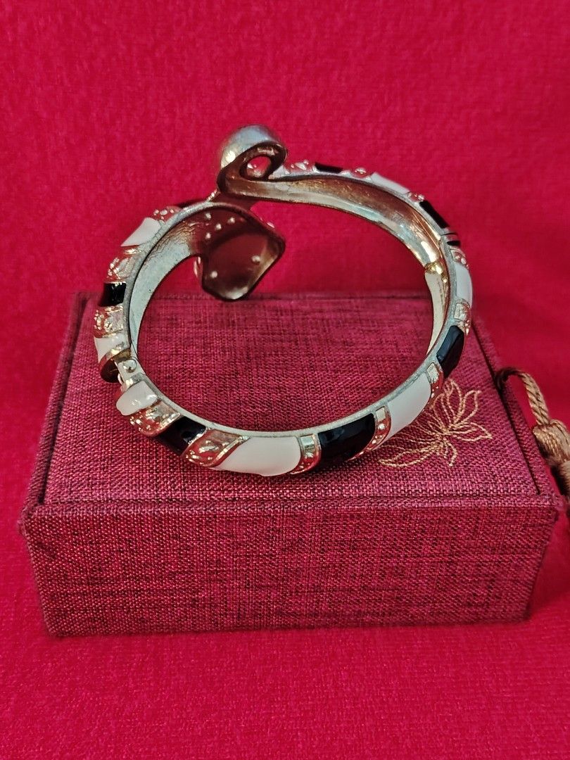 Black and White Snake Bangle Bracelet with Rhinestones (Category: Bracelets) located in Baguio. Submitted by ezelmix94436 (Listing ID 1464975084, Image 2). Description: - Eye-catching statement snake bangle bracelet - Chic black and white enamel stripes with gold-tone finish - Sparkly rhinestone crystals embedded along the head and body - Stunning large faceted crystal stone on the forehead - Convenient hinged design for easy wearing - Perfect ac