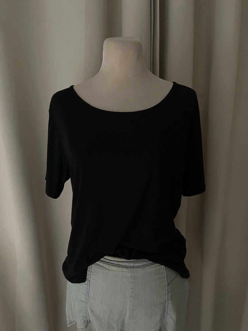 Black basic top (Category: Shirts) located in Cainta. Submitted by zlove111 (Listing ID 1465170079, Image 2). Description: - Color: Solid black - Fit: Relaxed fit through the body - Neckline: Wide scoop neck - Sleeves: Short sleeves - Material: Soft cotton-blend fabric - Styling: Versatile basic piece, perfect to pair with jeans, shorts, or skirts med-large .
