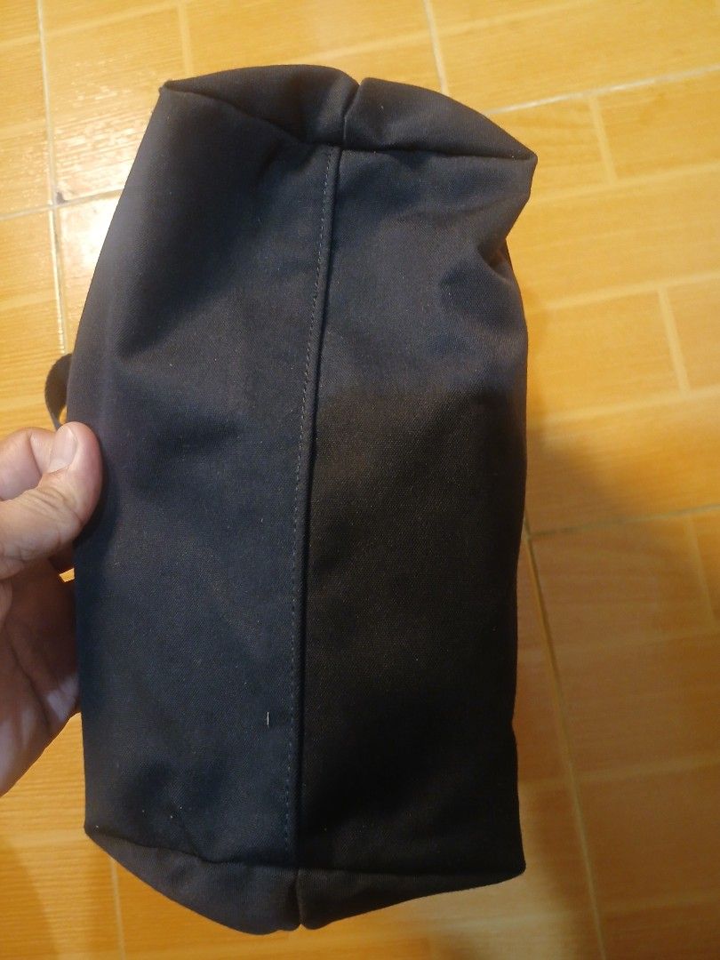 Black canvas messenger bag with buckle closure and strap (Category: Sling Bags) located in Manila. Submitted by asianwave189184 (Listing ID 1465095938, Image 3). Description: - Color: Black - Material: Durable canvas with fabric lining - Closure: Flap top with secure buckle strap - Strap: Adjustable shoulder strap for custom comfort - Storage: Roomy main compartment with a convenient back zippered pocket - Style: Simple, practical design ideal fo