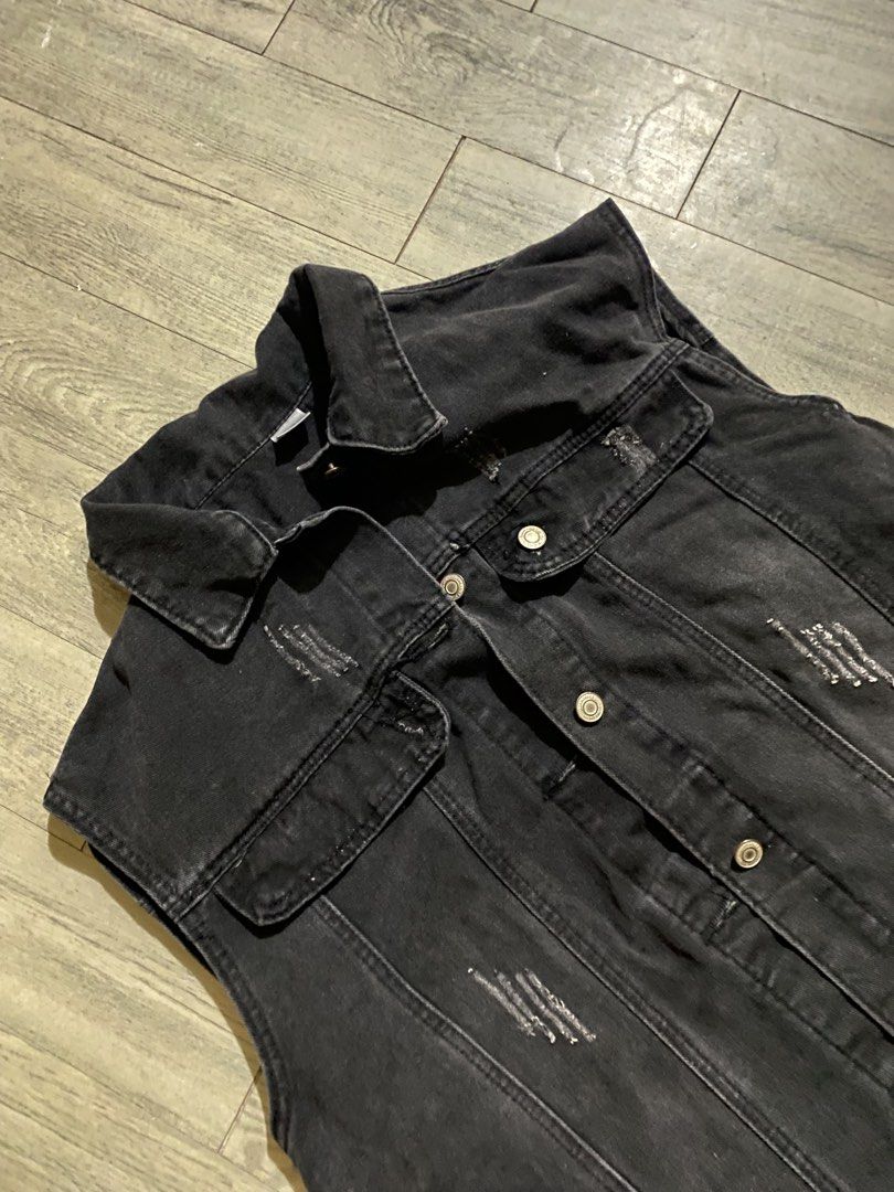 Black Distressed Denim Vest Sleeveless Jacket (Category: Formal Shirts) located in Caloocan City. Submitted by m1kk00 (Listing ID 1465002399, Image 2). Description: - Color/Wash: Black washed denim - Details: All-over distressing and classic collar neckline - Closures: Metal buttons down the front - Pockets: Two chest flap pockets and side pockets - Fit: Sleeveless cut, great for layering over tees or hoodies - Material: Heavyweight denim - Rare 