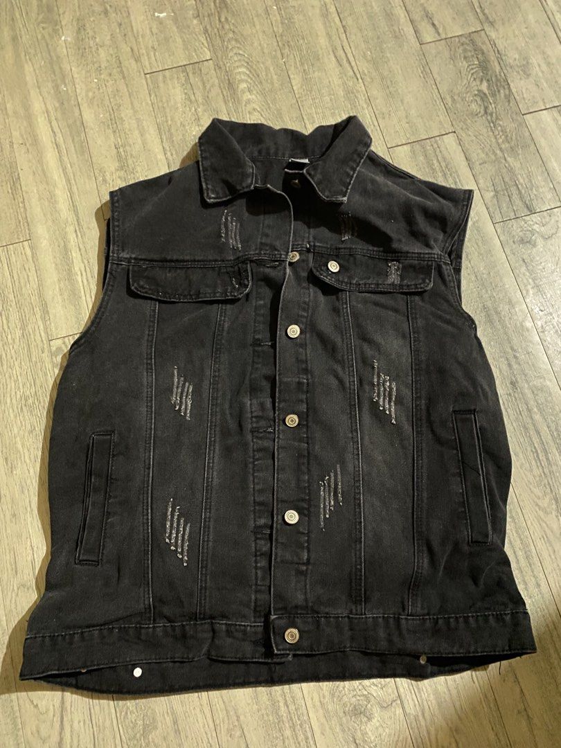 Black Distressed Denim Vest Sleeveless Jacket (Category: Formal Shirts) located in Caloocan City. Submitted by m1kk00 (Listing ID 1465002399, Image 1). Description: - Color/Wash: Black washed denim - Details: All-over distressing and classic collar neckline - Closures: Metal buttons down the front - Pockets: Two chest flap pockets and side pockets - Fit: Sleeveless cut, great for layering over tees or hoodies - Material: Heavyweight denim - Rare 