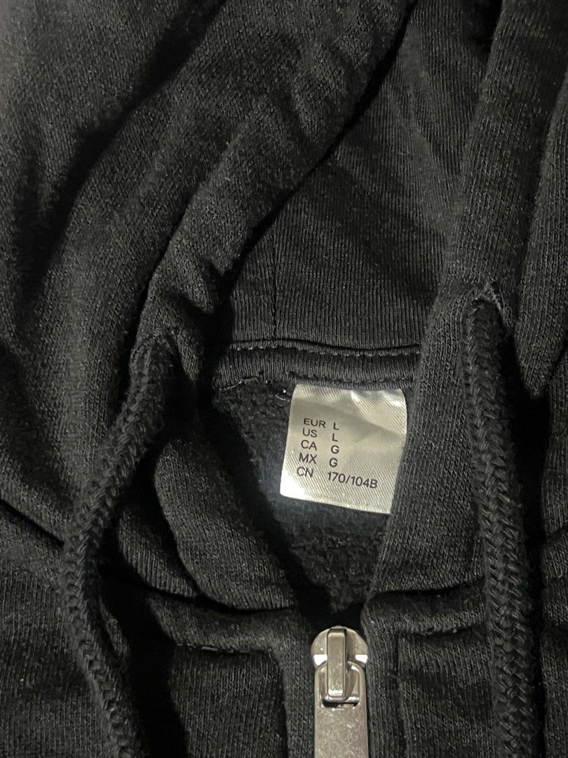 Black Full Zip Hoodie Size L (Category: Coats, Jackets and Outerwear) located in Manila. Submitted by goldenlion_0ba0c3 (Listing ID 1465063341, Image 2). Description: - Color: Solid black - Size: L (international sizing tag) - Hardware: Silver-tone front zipper - Features: Drawstring hood, ribbed cuffs and hem to lock in warmth - Style: Casual everyday streetwear.