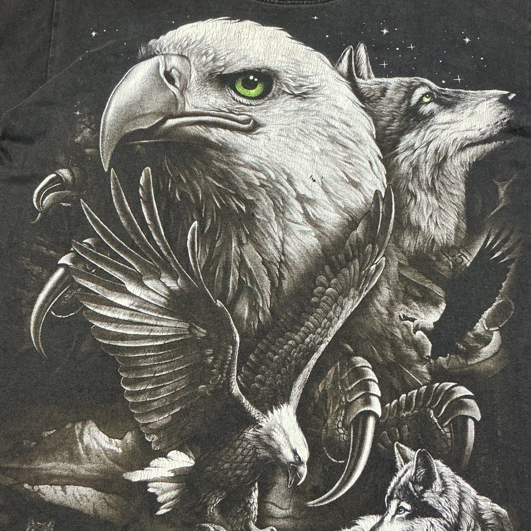 Black graphic t-shirt eagle wolf wildlife print (Category: Tshirts & Polo Shirts ) located in Naga. Submitted by lootersfinder (Listing ID 1464997716, Image 3). Description: Black t-shirt with large wildlife graphic print on the front and back. Detailed illustration features a bald eagle, wolves, and starry night sky backdrop. Short sleeves, crew neck. Cotton fabric. Regular fit..