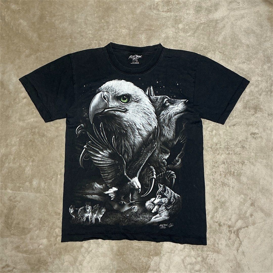 Black graphic t-shirt eagle wolf wildlife print (Category: Tshirts & Polo Shirts ) located in Naga. Submitted by lootersfinder (Listing ID 1464997716, Image 1). Description: Black t-shirt with large wildlife graphic print on the front and back. Detailed illustration features a bald eagle, wolves, and starry night sky backdrop. Short sleeves, crew neck. Cotton fabric. Regular fit..