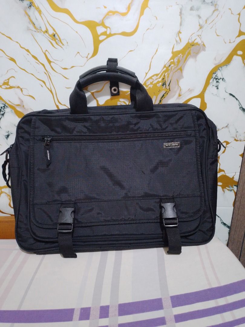 Black Laptop Bag Briefcase with Multiple Compartments (Category: Laptop Bags & Sleeves) located in Imus. Submitted by bestfinds_yeth0724 (Listing ID 1465162042, Image 1). Description: - Durable black nylon material - Front flap with plastic buckle clips and secure zippered pocket - Main compartment features a padded laptop sleeve with velcro strap - Includes internal pen slots and divider pockets - Convenient open pocket on the back - Sturdy top 