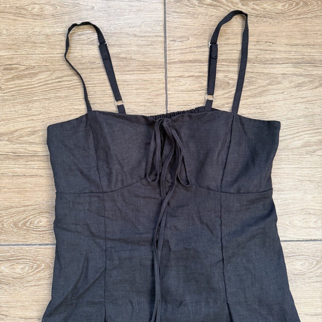 Black linen top with tie front and adjustable straps (Category: Sleeveless) located in Cainta. Submitted by nicsboo (Listing ID 1465087711, Image 2). Description: Bought this from bazaar in estancia around 700+ - Color: Black - Features: Adjustable spaghetti straps, front tie detail, and gathered bust - Comfort: Smocked elastic back panel for extra stretch - Fit: Flared peplum hem - Material: Lightweight and breathable fabric - Condition: Clean a