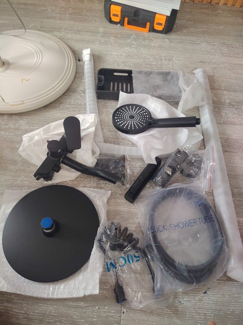 Black matte shower mixer set complete parts (Category: Bathroom & Kitchen Fixtures) located in Makati City. Submitted by cess_preloved (Listing ID 1464977203, Image 1). Description: Complete black matte shower mixer set. Includes handheld shower head, overhead rain disc, 150cm shower tube, storage shelf tray, mixer faucet valve body, and all installation pipes and brackets. Unpacked and laid out on the floor for checking. All pieces wrapped in or