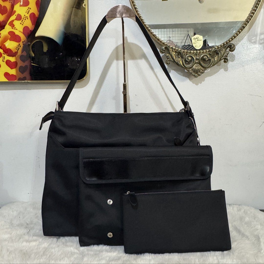 Black Nylon Shoulder Bag with Removable Pouch and Key Ring (Category: Shoulder Bags) located in Rizal. Submitted by houseofbell (Listing ID 1465151060, Image 3). Description: - Color: Sleek black with silver-tone hardware and zippers - Material: Durable nylon with brown interior lining - Storage: Spacious main compartment and multiple exterior pockets - Extras: Includes a matching detachable pouch - Convenience: Features a built-in interior key h