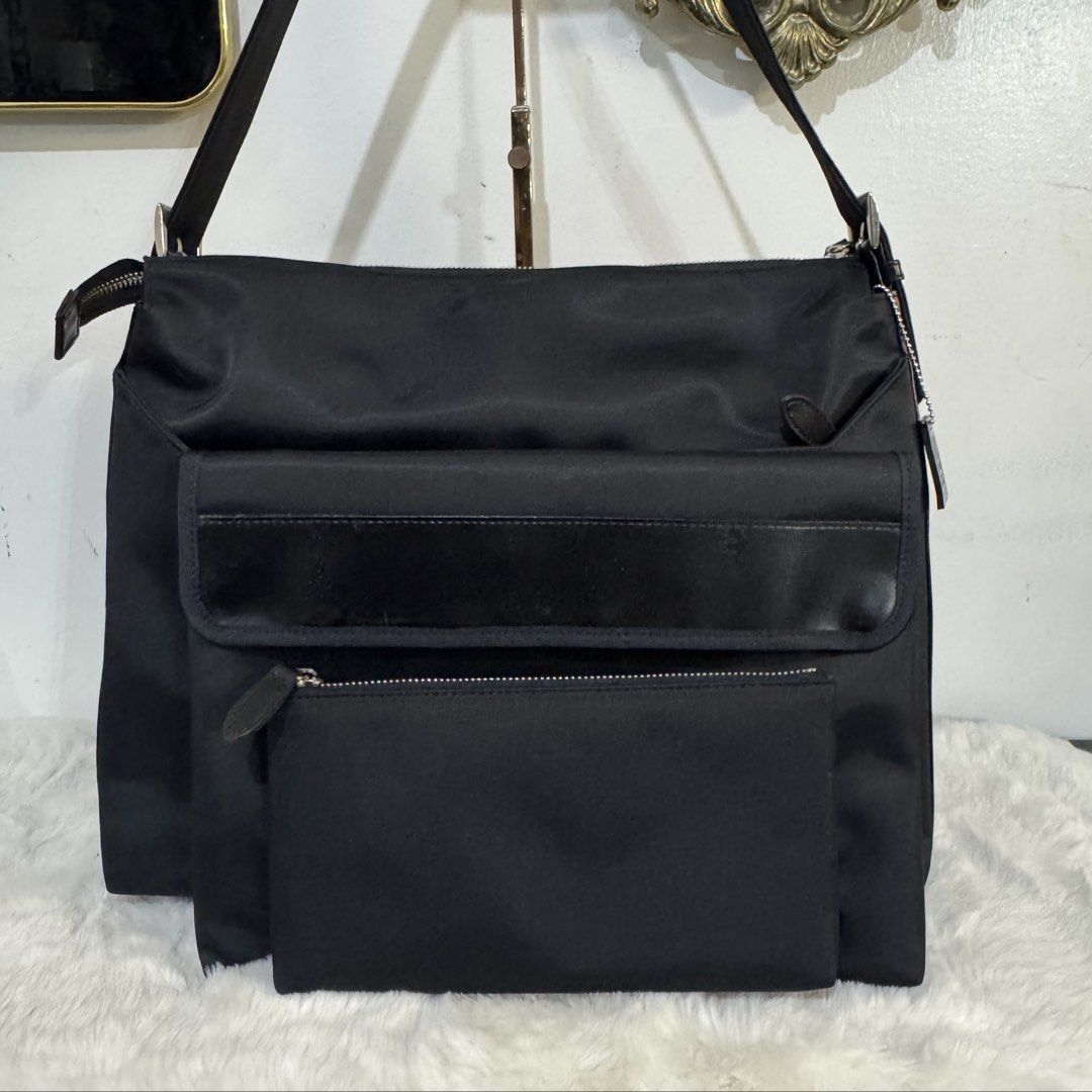 Black Nylon Shoulder Bag with Removable Pouch and Key Ring (Category: Shoulder Bags) located in Rizal. Submitted by houseofbell (Listing ID 1465151060, Image 2). Description: - Color: Sleek black with silver-tone hardware and zippers - Material: Durable nylon with brown interior lining - Storage: Spacious main compartment and multiple exterior pockets - Extras: Includes a matching detachable pouch - Convenience: Features a built-in interior key h