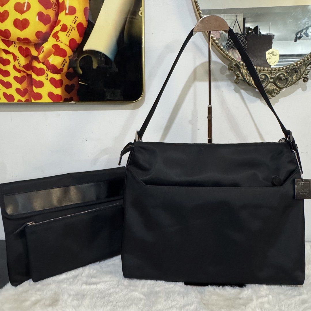 Black Nylon Shoulder Bag with Removable Pouch and Key Ring (Category: Shoulder Bags) located in Rizal. Submitted by houseofbell (Listing ID 1465151060, Image 1). Description: - Color: Sleek black with silver-tone hardware and zippers - Material: Durable nylon with brown interior lining - Storage: Spacious main compartment and multiple exterior pockets - Extras: Includes a matching detachable pouch - Convenience: Features a built-in interior key h