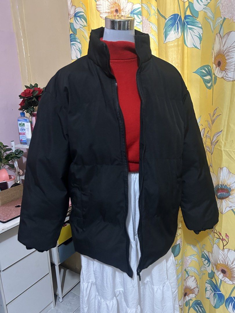 Black Puffer Jacket Winter Outerwear (Category: Coats, Jackets and Outerwear) located in Makati City. Submitted by aizy_sell (Listing ID 1465027568, Image 3). Description: - Color: Solid black (easy to match with any outfit) - Material: Thick padded material for maximum warmth and clean outer fabric - Design: High collar, full zip closure, and relaxed fit through the body - Features: Ribbed cuffs to block the wind and two front side pockets - Con
