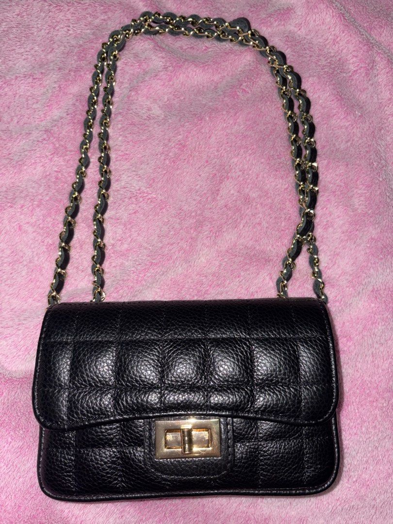 Black Quilted Leather Chain Shoulder Bag (Category: Shoulder Bags) located in San Juan City. Submitted by sundaybyaly (Listing ID 1465031361, Image 2). Description: - Style: Black quilted leather shoulder bag with textured finish - Hardware: Elegant gold-tone with secure front twist-lock closure - Straps: Double chain strap interwoven with matching black leather - Interior: Fabric-lined with a convenient zippered pocket - Origin: Made in Italy - 